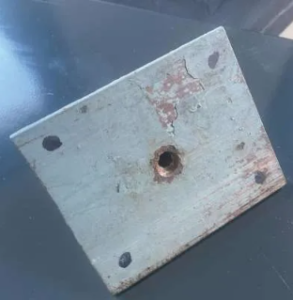 Rustic metal plate with central hole and screws